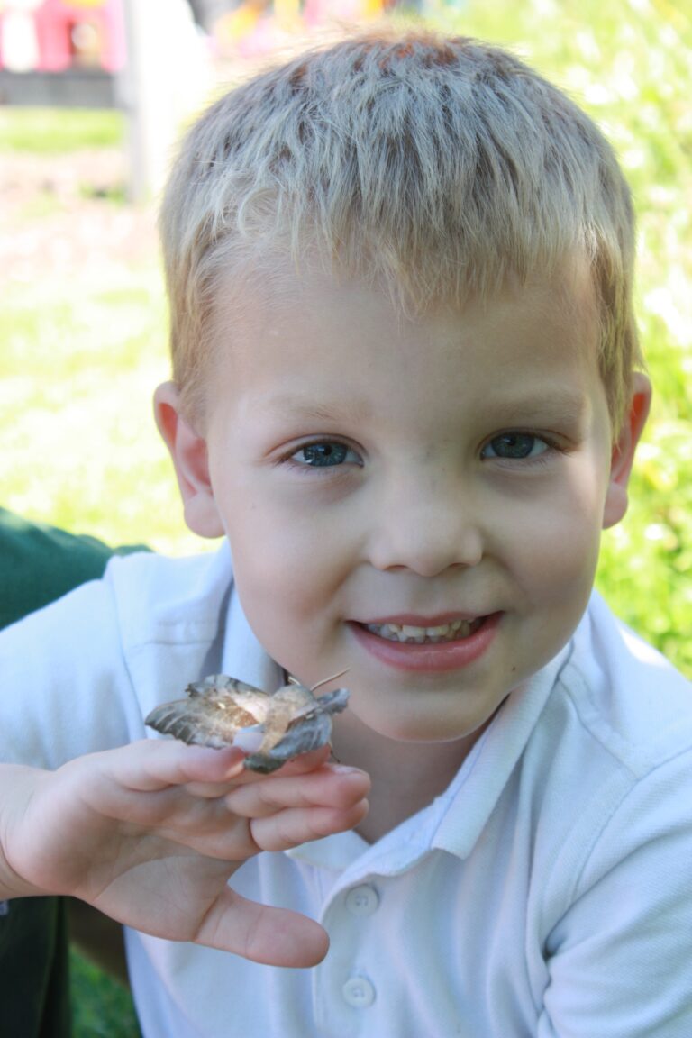 Education 10 Child from Bury School nature film holding a moth in the South Downs National Park
